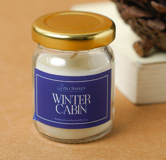 Winter Cabin mini scented jar candle in a 40g glass jar, infused with warm, woody notes for a cozy and comforting ambiance. Perfect for intimate spaces and gifting.